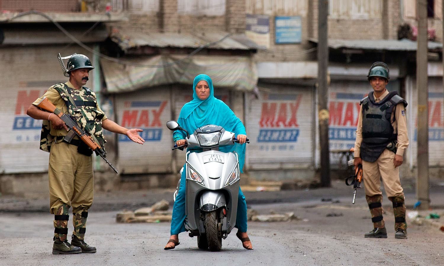 Indian paramilitary soldiers stop a Kashmiri woman during curfew in Srinagar. —AP/File