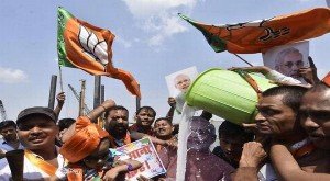 BJP workers milk bath a cutout of Prime Minister Narendra Modi as they celebrate Assembly elections results in Patna on Sunday. 
